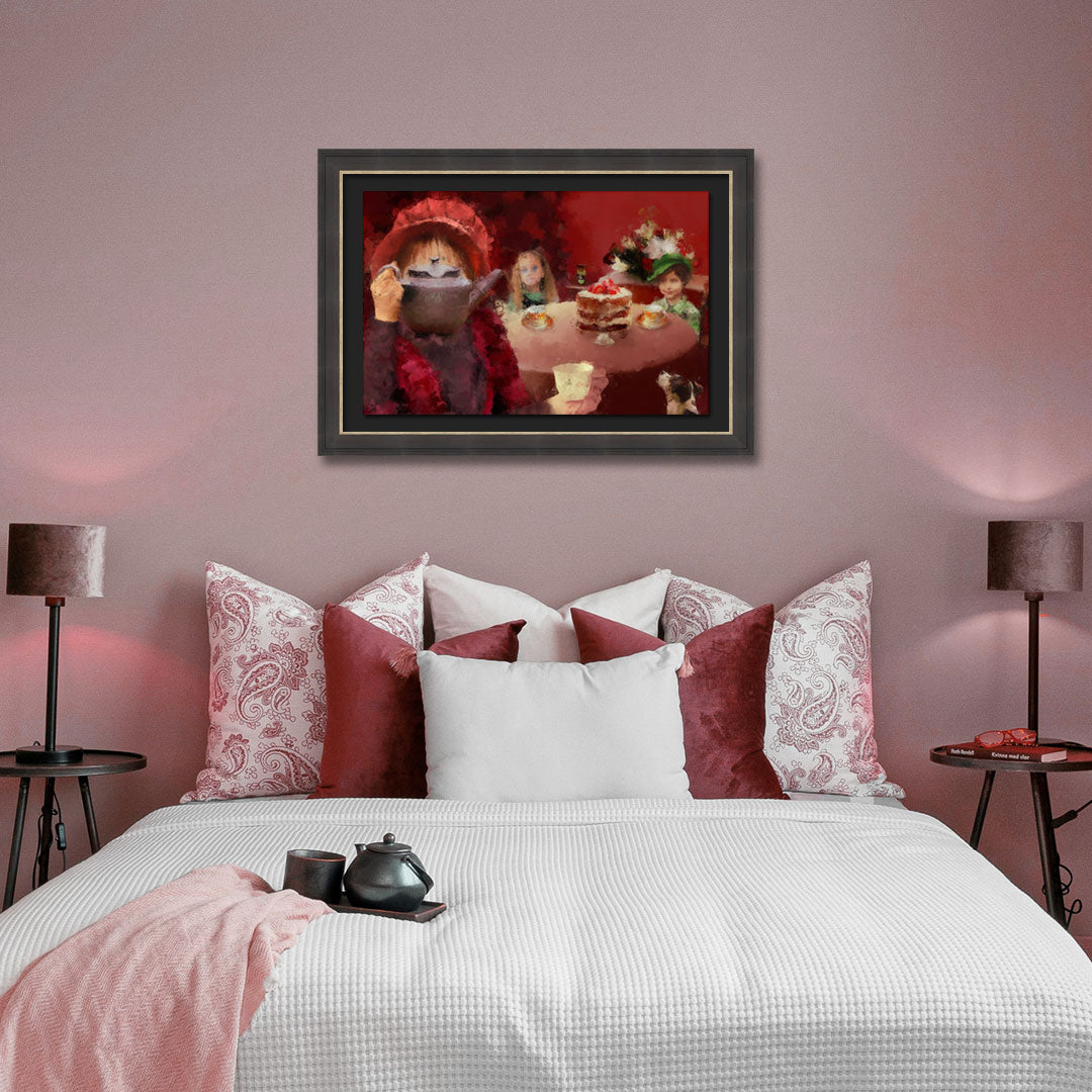 A framed art print depicting a whimsical tea-time scene, displayed on a dusty rose wall above a bed styled with red and white patterned pillows, white bedding, and bedside lamps.
