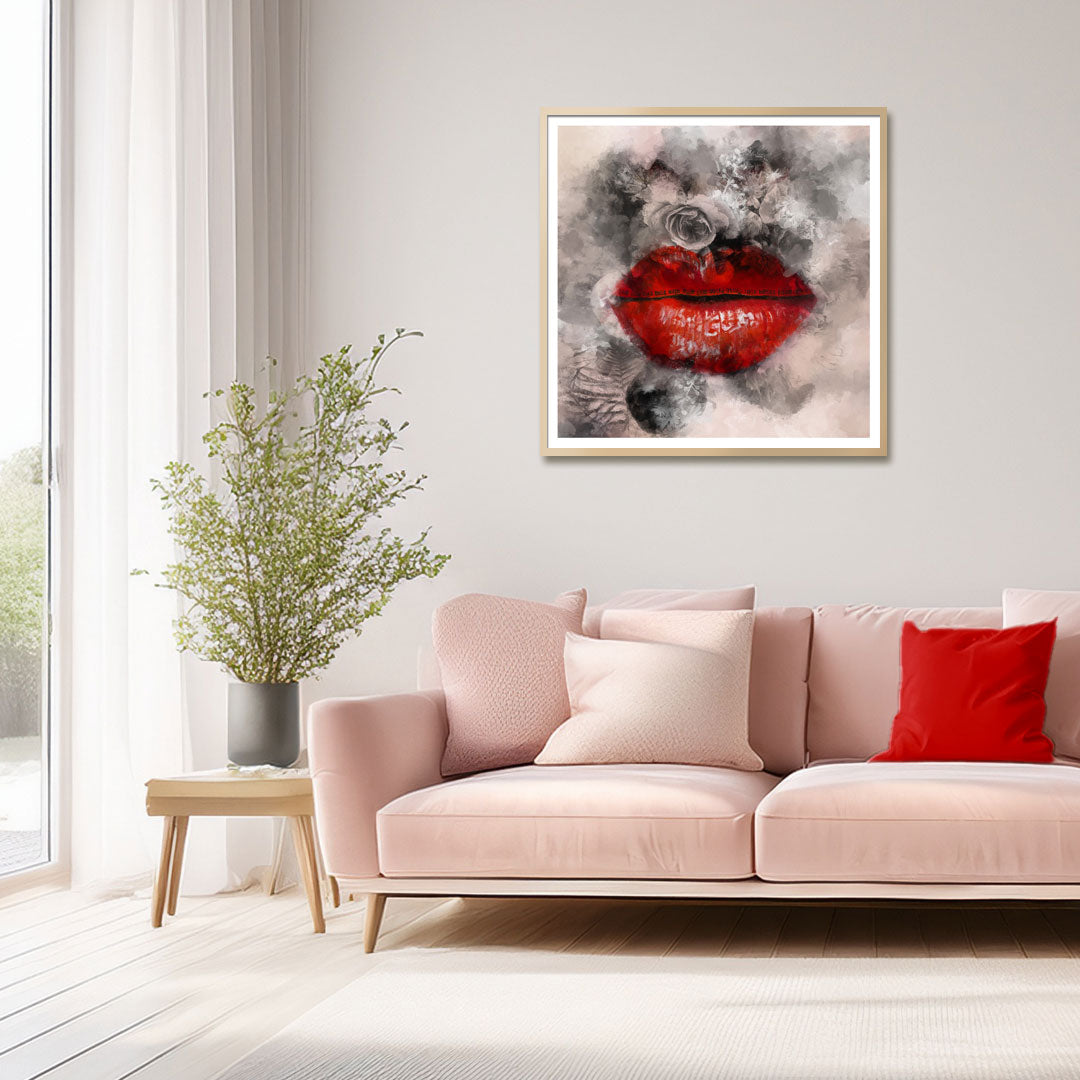 A framed wall art print featuring a close-up of red lips with gray smoke effects, displayed above a light pink sofa in a bright, modern living room.